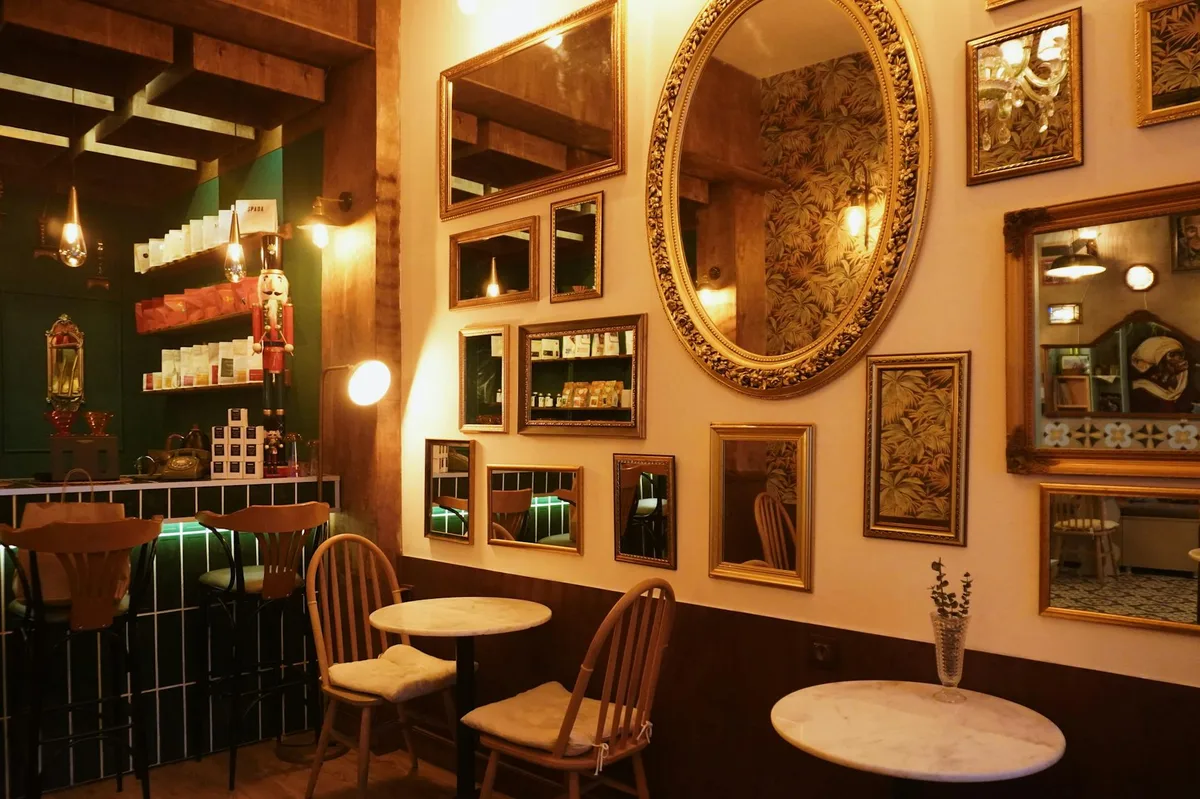 Warm toned café interior with vintage mirrors and wooden decor in Eskişehir, Türkiye.