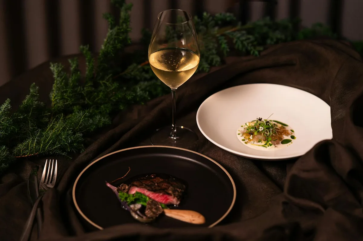 Elegant dining setup with gourmet meal and wine in a Tokyo restaurant.