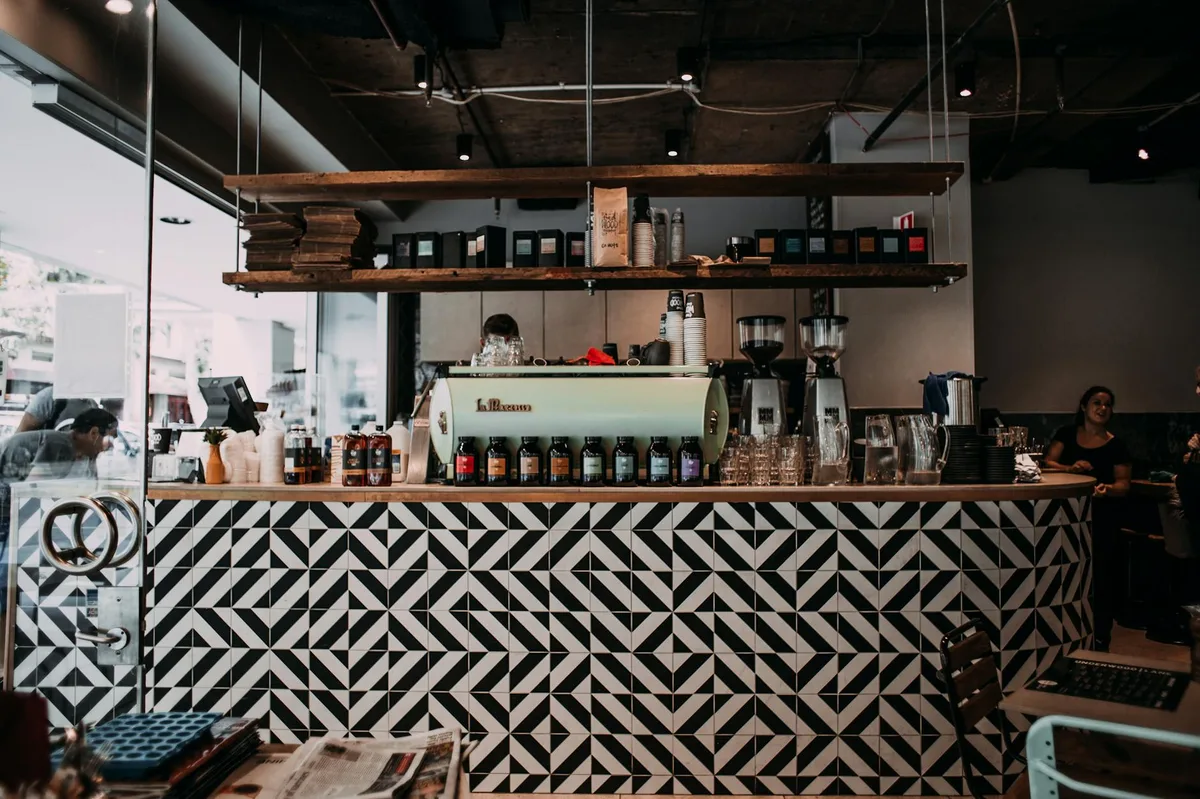 Stylish cafe interior featuring a patterned counter and modern decor, ideal for coffee enthusiasts.